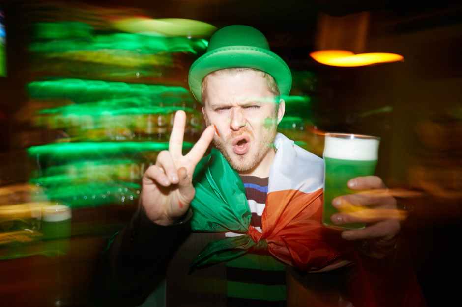 man holding a green drink
